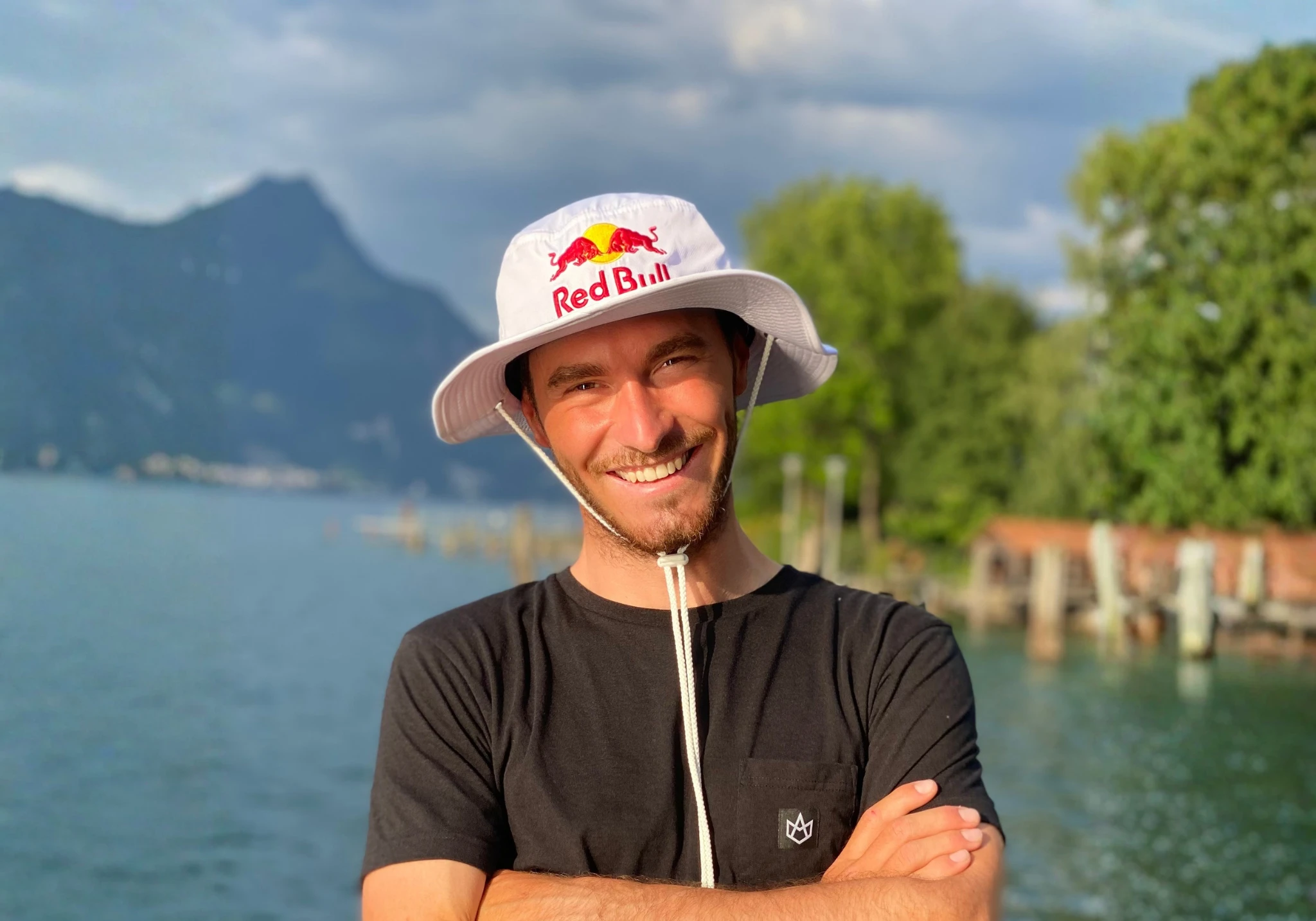 Maxime Chabloz by the lake with mountains in the background